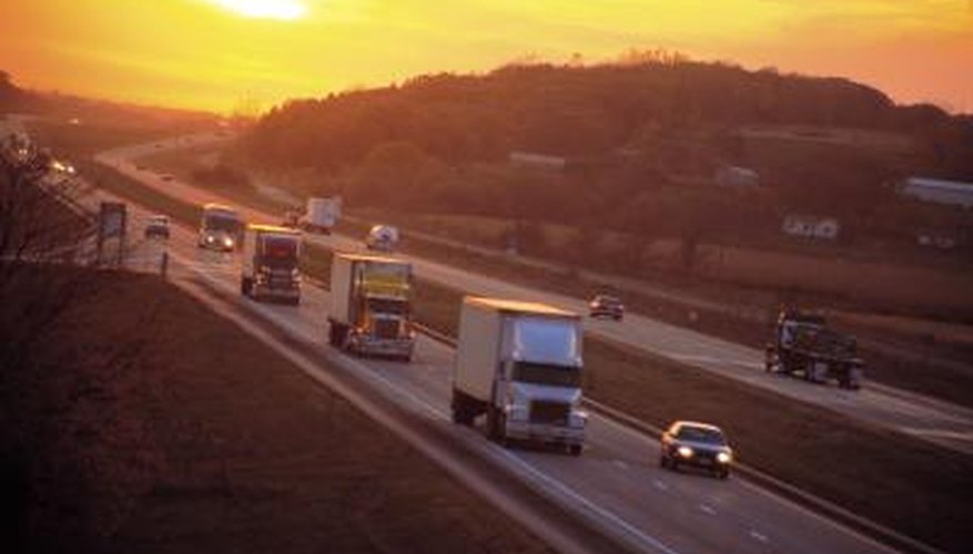 Cars and trucks driving on a highway Cars and trucks driving on a highway