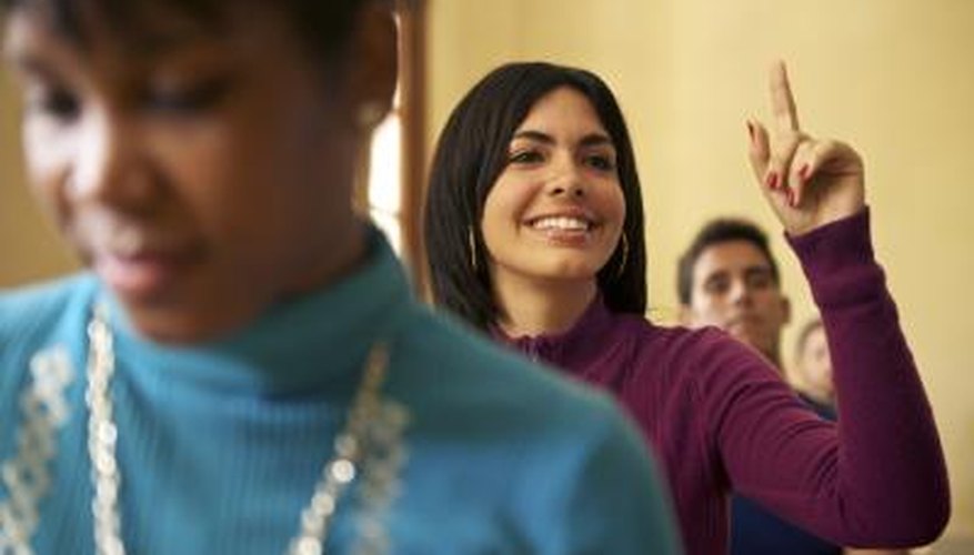 A woman in line makes a gesture with her hand. A woman in line makes a gesture with her hand.