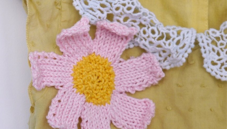 A hand knit flower brooch makes a sweet dress even sweeter. A hand knit flower brooch makes a sweet dress even sweeter.