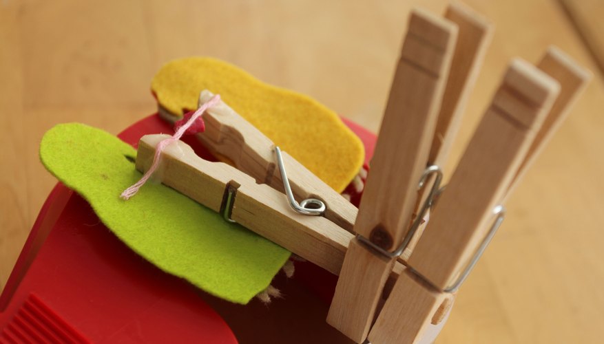 Pinch the clothespin open, using additional clothespins. Pinch the clothespin open, using additional clothespins.