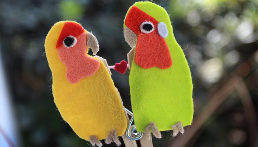 Felt lovebirds kiss and share their love. Felt lovebirds kiss and share their love.