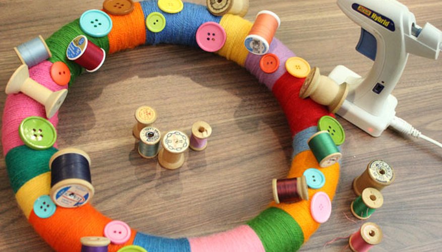 Glue spools of thread to the wreath Glue spools of thread to the wreath