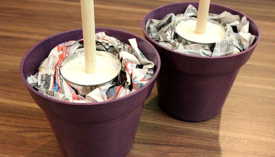 Place cans in decorative planters Place cans in decorative planters