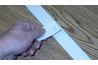 Here's a nail pushed through the piece of paper. Once the nail is driven in, simply pull out the paper.