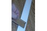 Slit in the cardboard strip holds the nail in position.