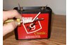 Wire-wrapped screwdriver and battery.