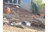 An excavation process of a hillside water garden with waterfall