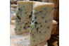 Blue cheese has a creamy white base with bluish veins running through it.