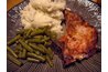 Southern foods: pork chops, mashed potatoes and green beans.