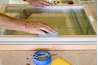 Fine sandpaper gives a window frame a smooth surface.