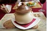 Clay pots are used in various ways for cooking.