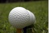 Combine old clubs and golf balls to make a table.