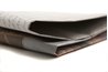 Cut newspaper into strips.