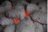 Evenly distribute hot coals on each side of the drip pan.