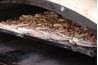 Italian bread tends to be cooked in a stone or wood-burning oven; the same ovens they use to cook pizzas.