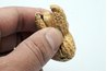 Crack the peanut shells open with your hands.