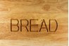 A roll-top bread box fits neatly on your counter and needs no extra room for swinging doors.