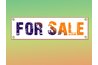 Put up a large "for sale" sign advertising a commercial land opportunity.