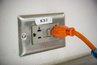 A grounded outlet has a reset switch in its center.