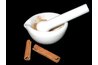 A stone mortar and pestle work efficiently to grind whole cinnamon by hand.