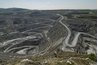 Pit mining involves removing the top layers of sediment to reach the desired product.