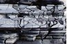 Slate stays relatively flat, although it can scratch or crack with extreme wear.