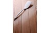 A wooden scraper can remove the softened plastic wrap without scratching stainless steel.