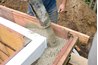 Pouring concrete in a wall mold.