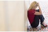 Frustrated woman sitting on floor