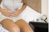 Woman holding upset stomach