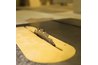 The nut that holds the blade in place is found under the blade cover.