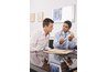 Man with doctor looking at model of joint