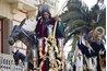 Nativity statues grace a float in the street during a parade.