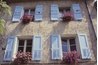 Semi gloss shutters add detail to a flat stucco wall.