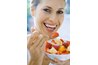 Woman eating fruit salad