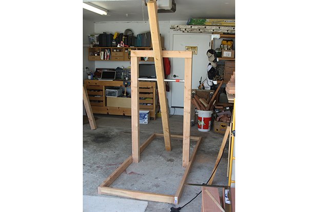 Assembled structure with pipe threaded through 4x4s.