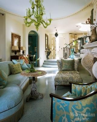 The curved wall shape is picked up in the roundness of the sofa and the backs of the chairs.