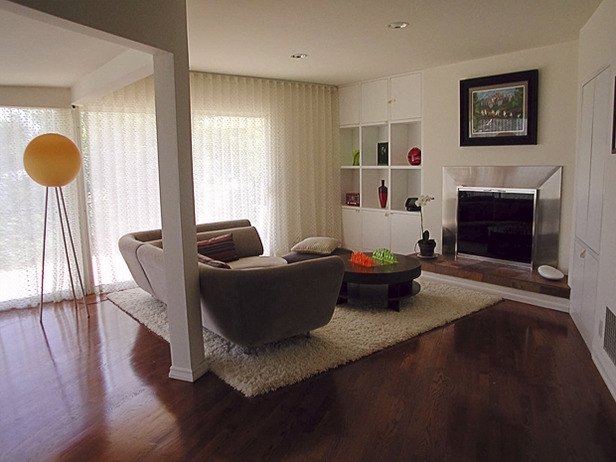 This room has angles and columns. The seating area is defined by the rug and the angle accented by the hardwood floors.