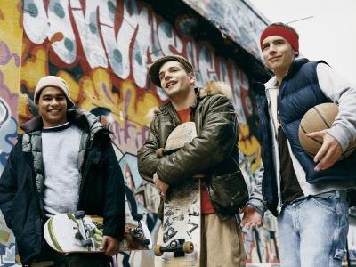 Teenagers walking with skateboards