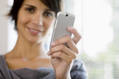 woman holding cell phone woman holding cell phone