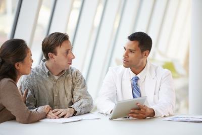 couple speaking with doctor
