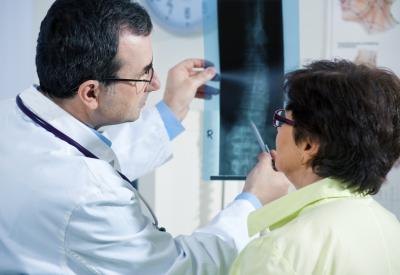 Examining a spinal x-ray. Examining a spinal x-ray.