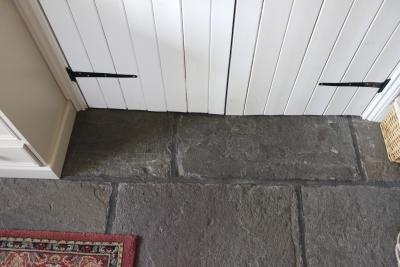 Walls and doors that are painted different shades of white in a cottage sitting room.