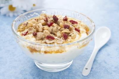 Glass bowl of yogurt topped with granola.