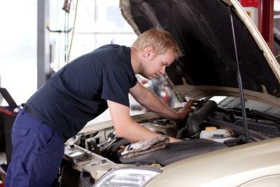 Mechanic fixing car engine