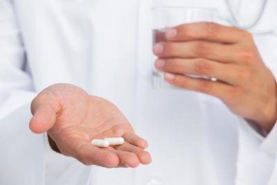 doctor holding out antibiotics
