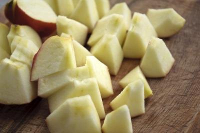 Chopped apple pieces on a wood table