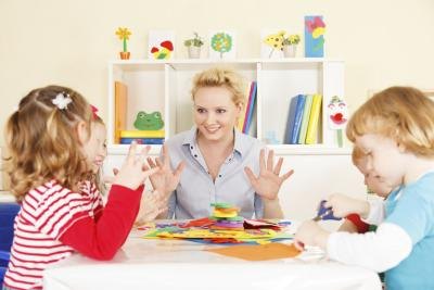 A preschool teacher giving a math lesson.