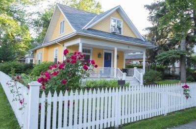 White picket fence with bungalow landscape