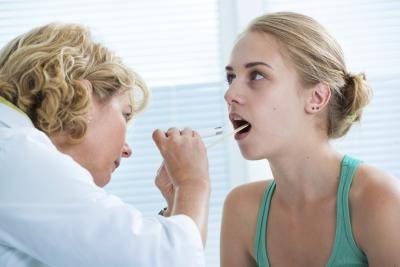 Doctor looking in patients mouth